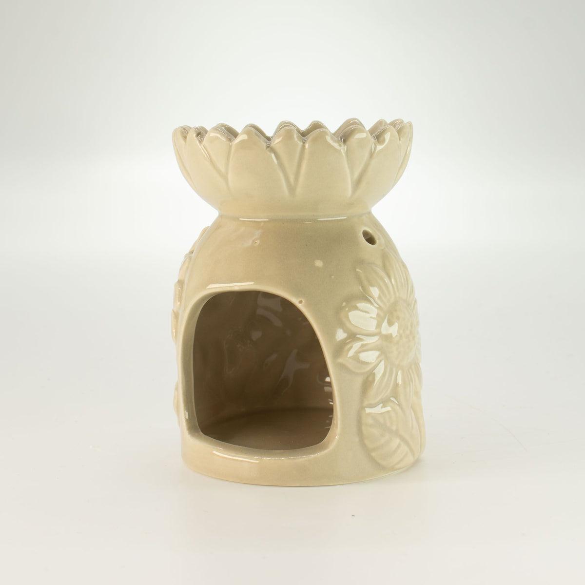 Beige ceramic oil burner with floral design on a white background