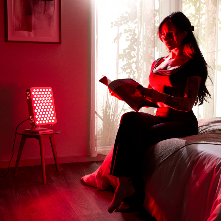 Woman reading a book in a room with red light panel