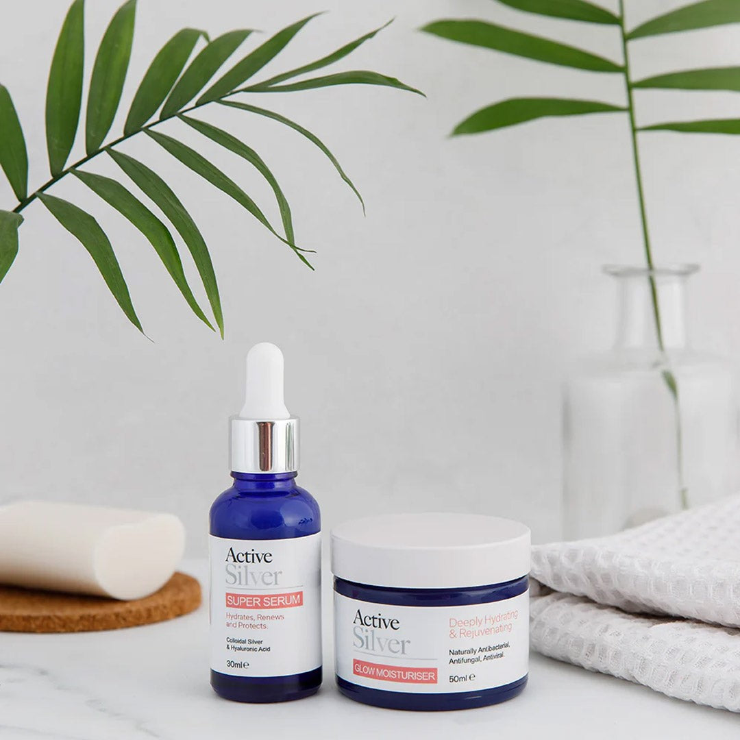 Active Silver Super Serum and Glow Moisturiser Duo on a bathroom shelf