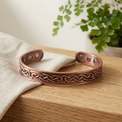 Celtic copper bracelet styled on oak with natural linen
