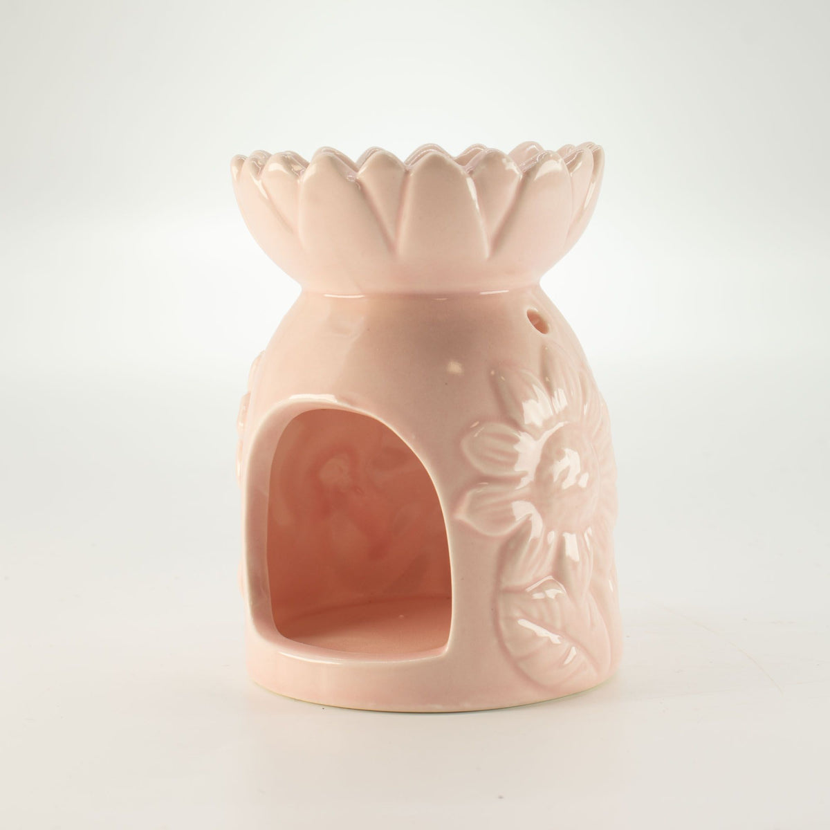Side view of ceramic pastel pink sunflower oil burner