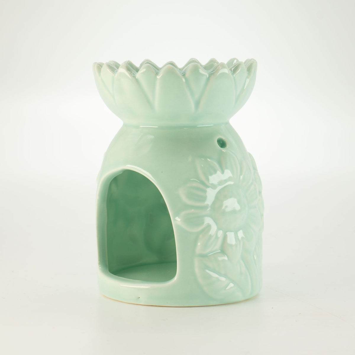 Ceramic sunflower oil burner in pastel green side view