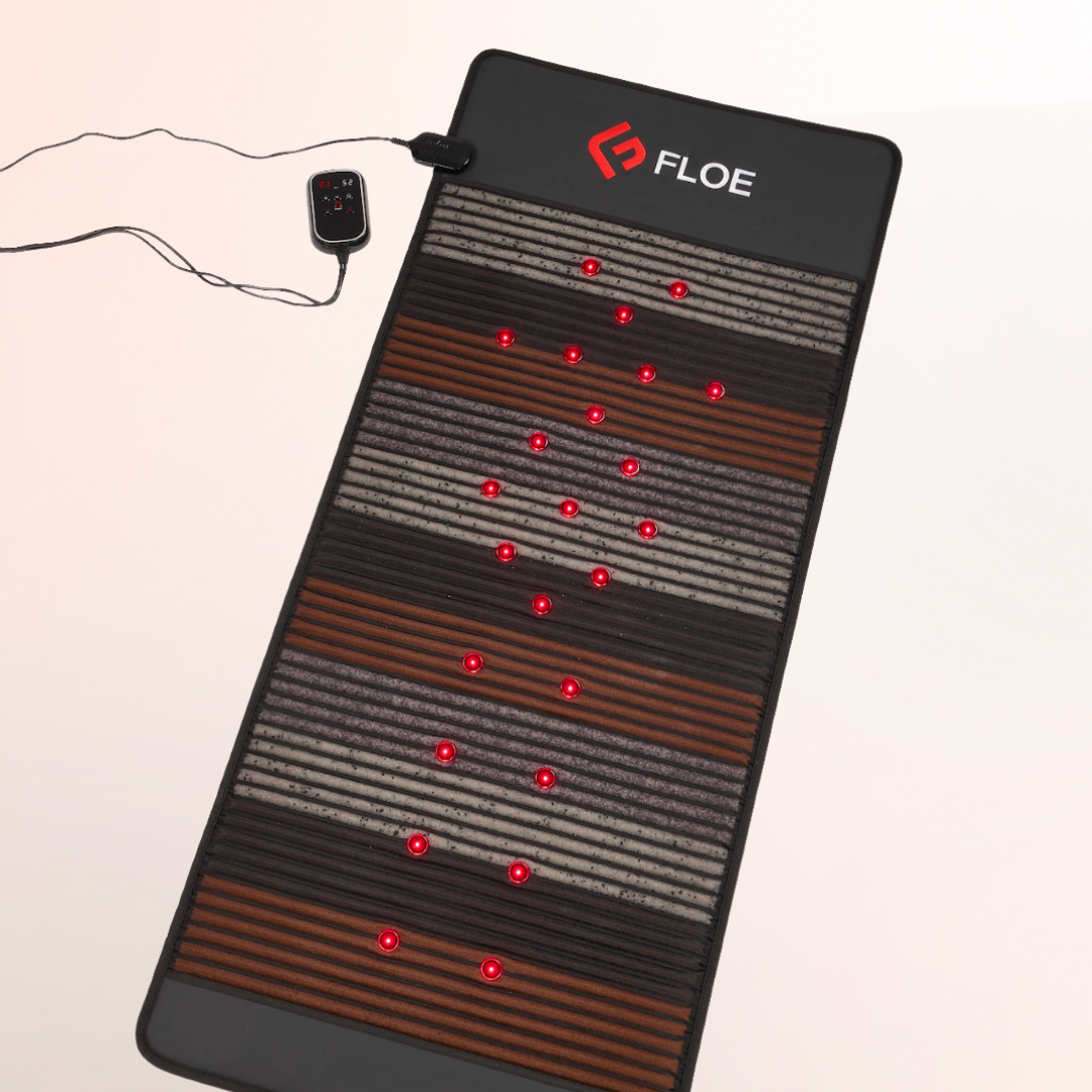 Floe infrared pemf mat with red LED lights on a beige background