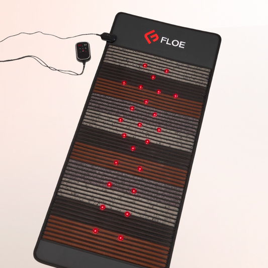 Floe infrared pemf mat with red LED lights on a beige background