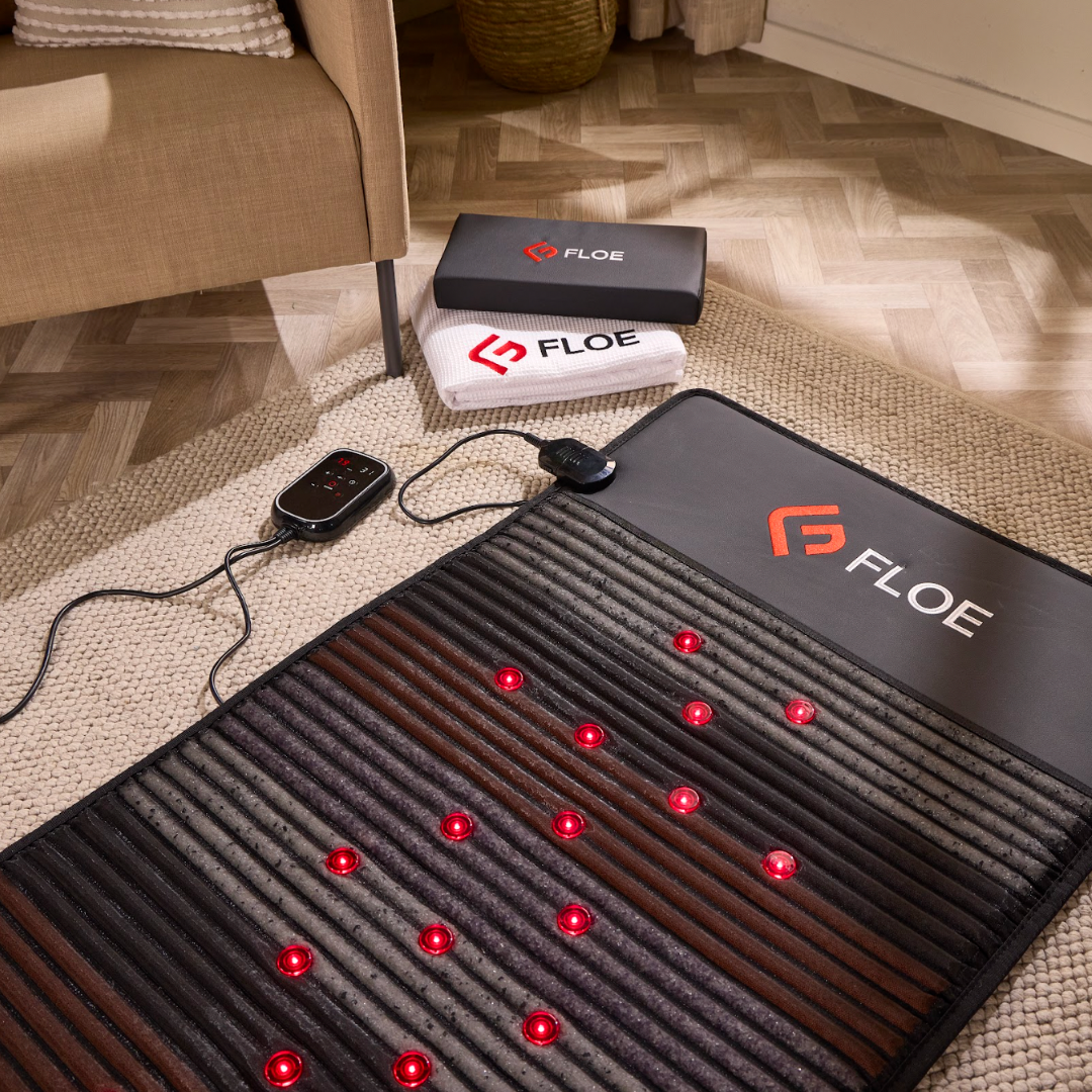 Floe infrared pemf mat with control device on a living room floor
