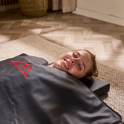 Woman relaxing in the Floe infrared sauna blanket