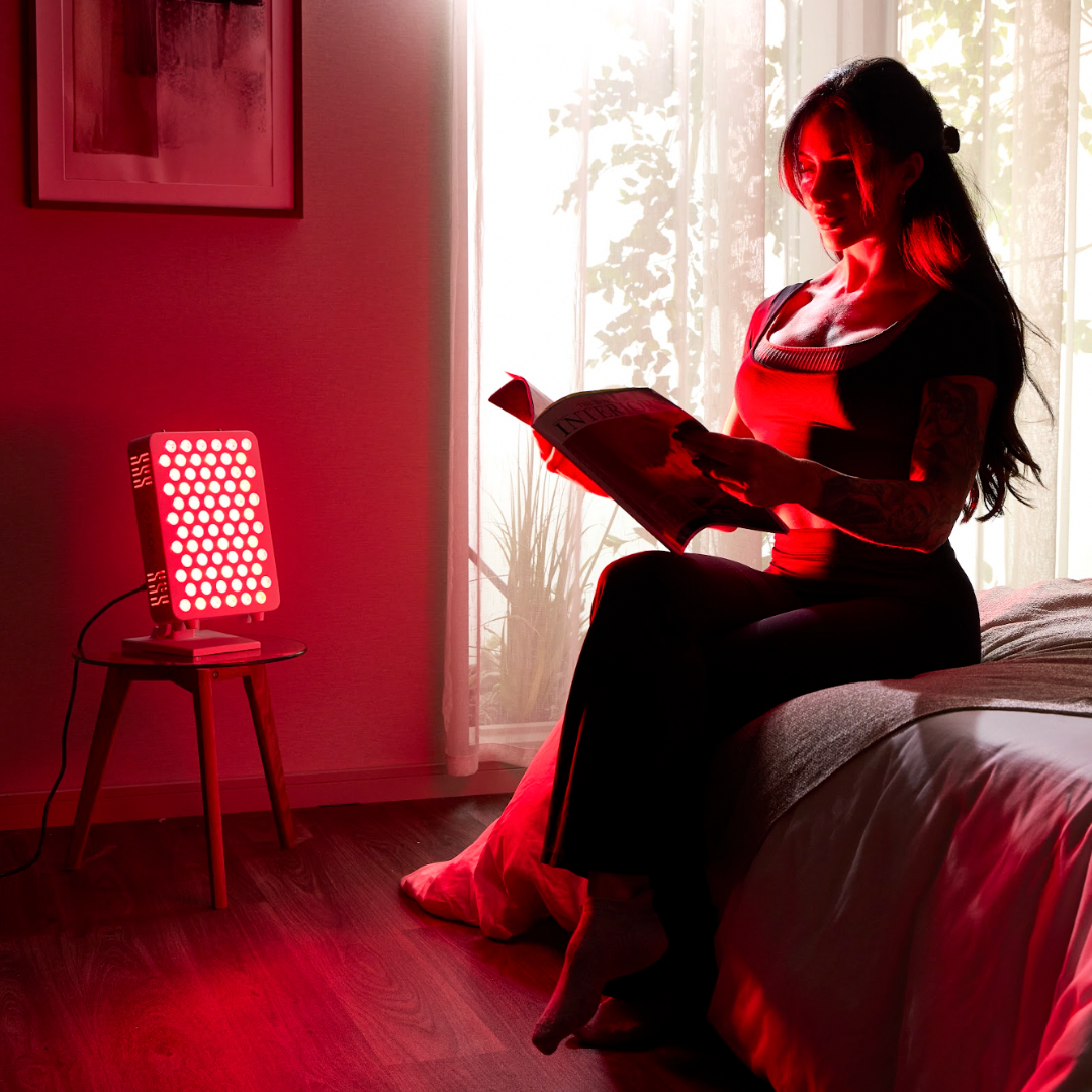 Woman reading a book in a room with red light panel
