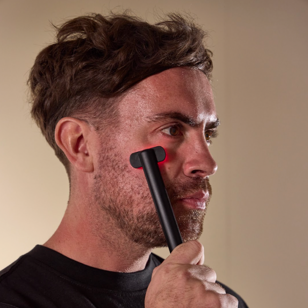 Man using the Floe red light therapy wand