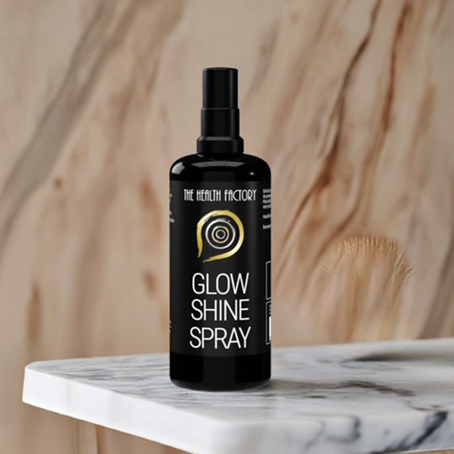 The health factory glow & shine spray 100ml on a marble table