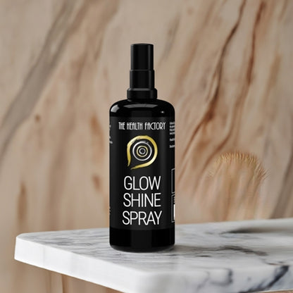 The health factory glow & shine spray 100ml on a marble table