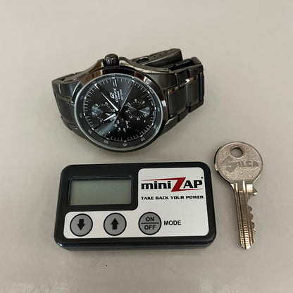 Showing a Minizap next to a watch and key for size comparison