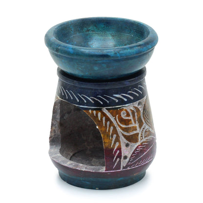 Soap stone oil burner with blue top and patterned base on a white background