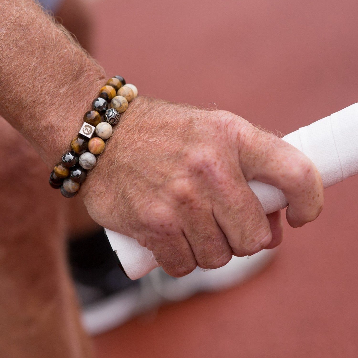 Playing tennis wearing a Zen-Z Karma Tiger Eye magnetic bracelet
