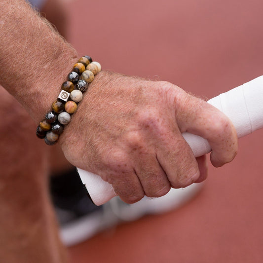 Playing tennis wearing a Zen-Z Karma Tiger Eye magnetic bracelet